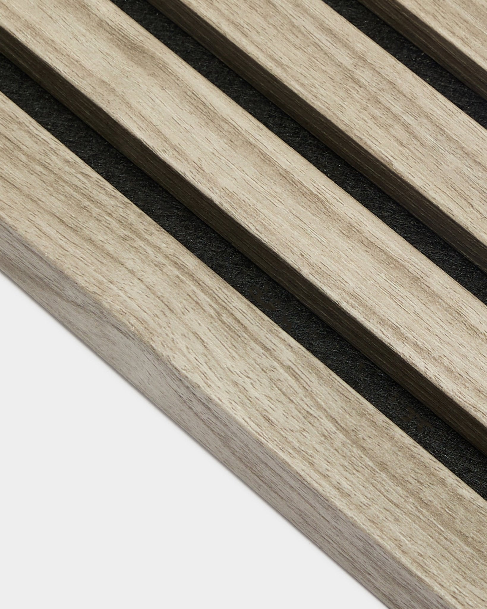 Nærbilde av WoodUpp Akupanel End Lamella i Weathered Oak, 2,2 cm – lyse nordiske eikespiler til akustikkpanel med black filt bakside mot hvit bakgrunn.