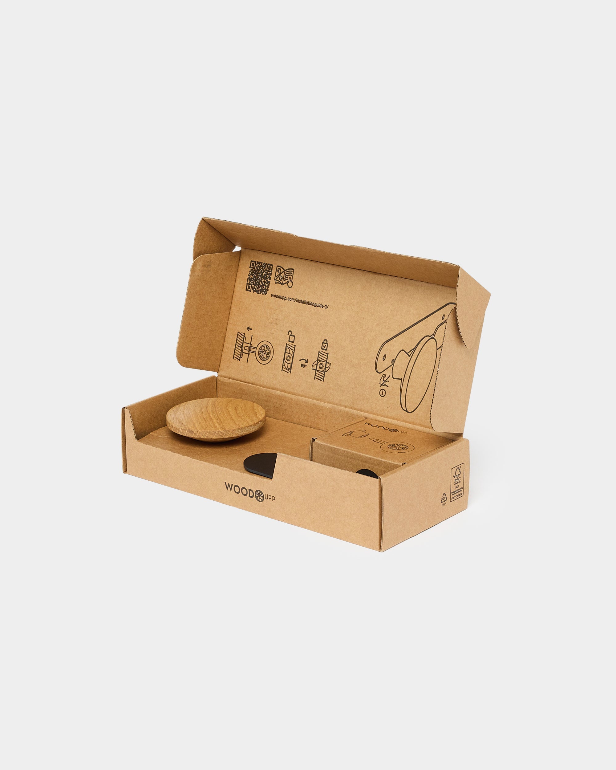 Open brown cardboard box with a round acoustic panel and assembly instructions printed on the inside of the lid.
